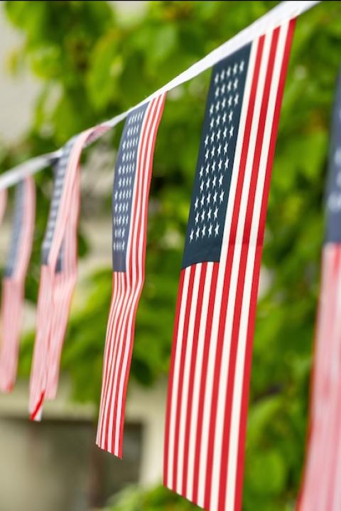 American flag bunting hanging in a yard for the Fourth of July — how employee-owned companies embrace independence