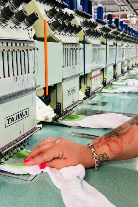 An employee sews socks at a FutureStitch manufacturing facility. 