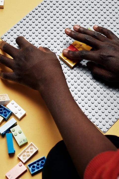 A child using Lego Braille Bricks. 