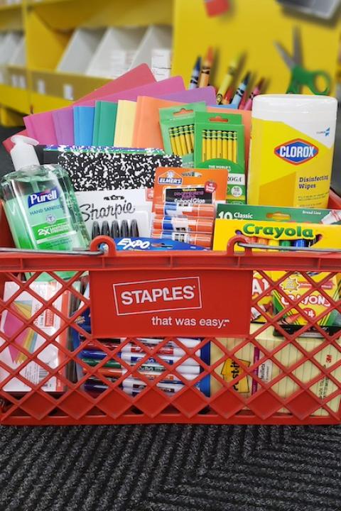 School supplies in a Staples shopping basket. 