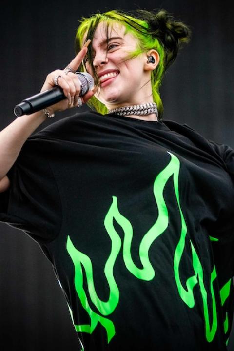 Billie Eilish singing into a mic. 