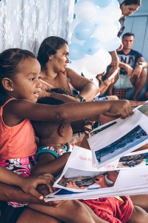 Children and adults sit together participating in The Waterschool curriculum in Brazil — Swarovski Foundation