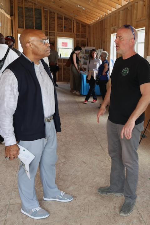 Grady Crosby the wooden foundation of an affordable home under construction with a group of others — affordable housing