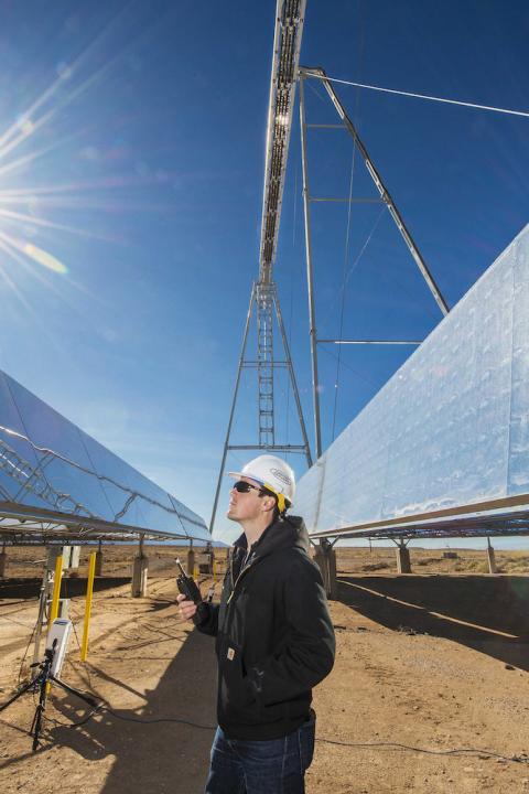 concentrating solar power - man stands at solar-thermal testing site in new mexico usa - clean power