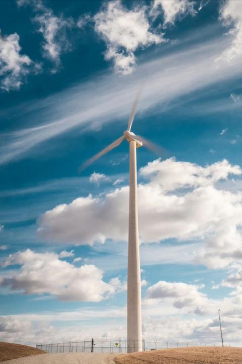 A wind turbine in front of a cloudy sky — data center