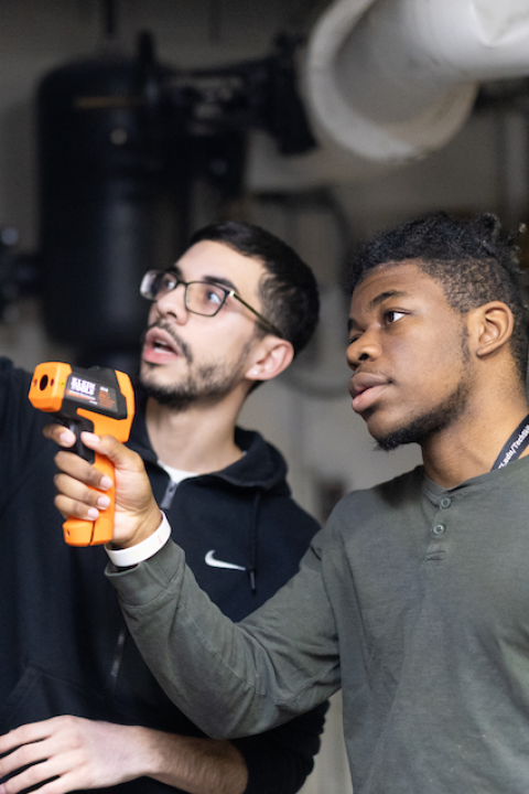 David Sepulveda advising a student during a hands-on green building lesson — green jobs