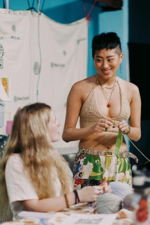 young people repair clothes at a sideline event during climate week 2023 - storytelling for climate justice