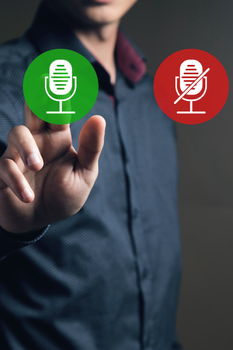 icons of enabled and disabled microphone. Man tapping on the screen — metaphor for whether companies should make their sustainability goals public or not
