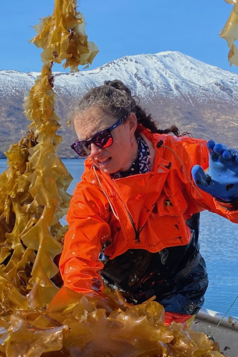 woman on a boat in Alaska processing seaweed for use in SuperCrude