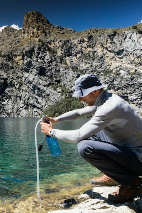 man collecting water from spring — citizen science 