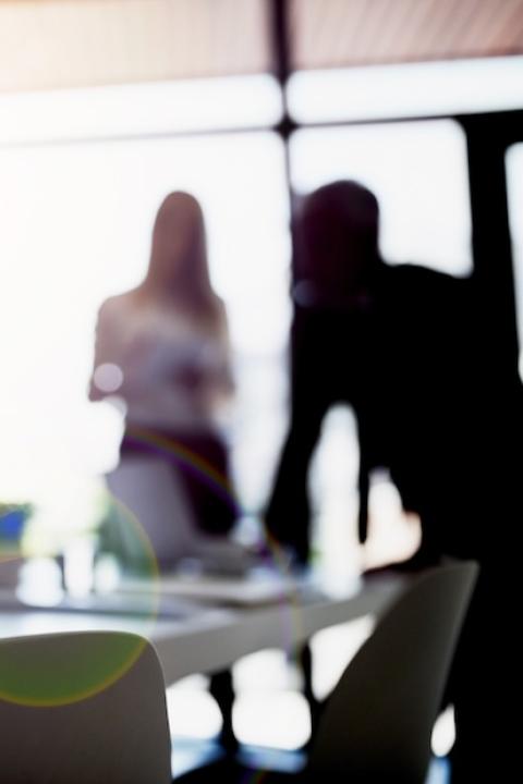 people talking in a board room — ESG is here to stay