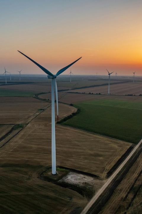 A wind farm at sunset — renewable energy 