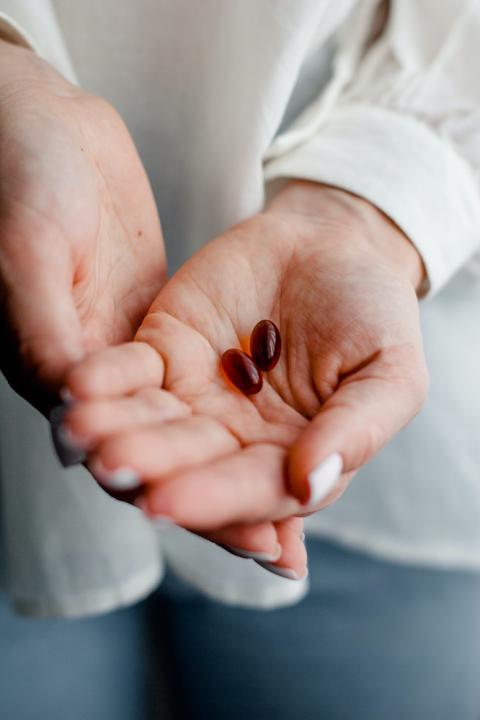 woman with pills in hand - abortion medication mifepristone