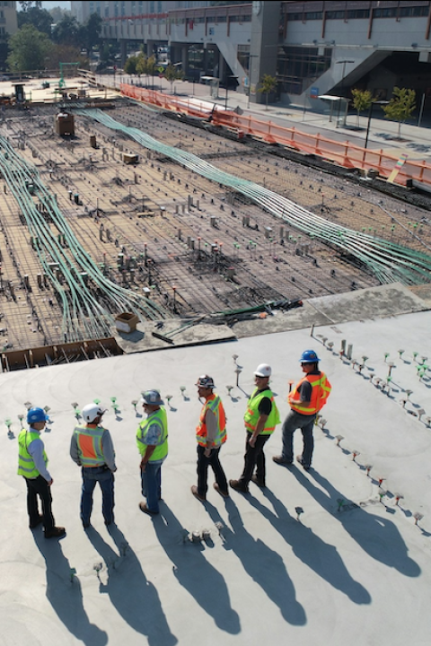 workers on a construction site — green building 