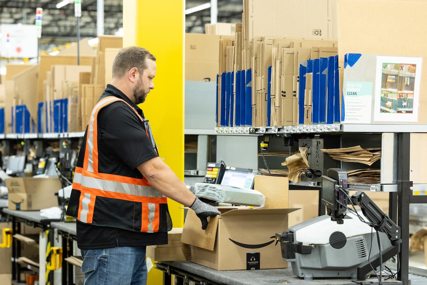 An Amazon employee packaging an order — artificial intelligence.