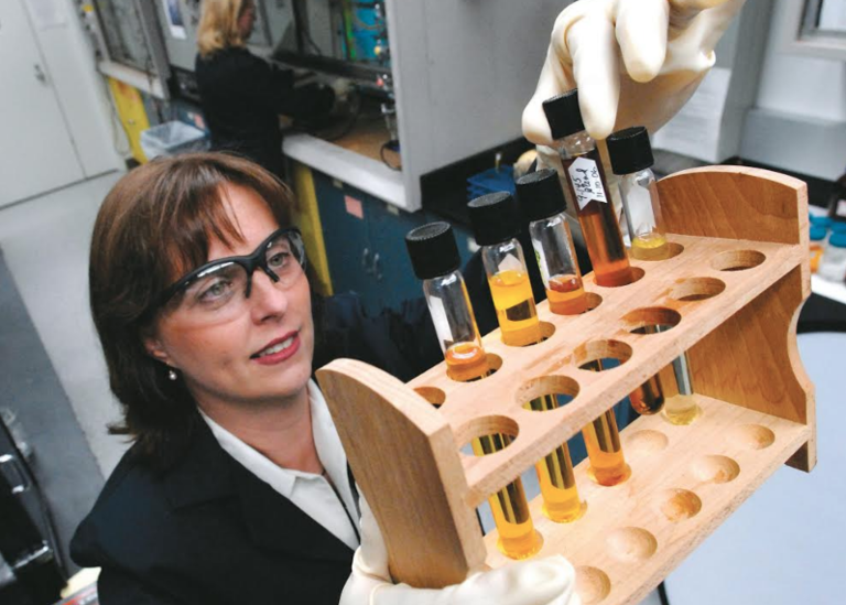 Debbie-Mielewski-a-technical-leader-at-Ford-shows-off-some-potential-bio-based-materials-in-a-lab.png