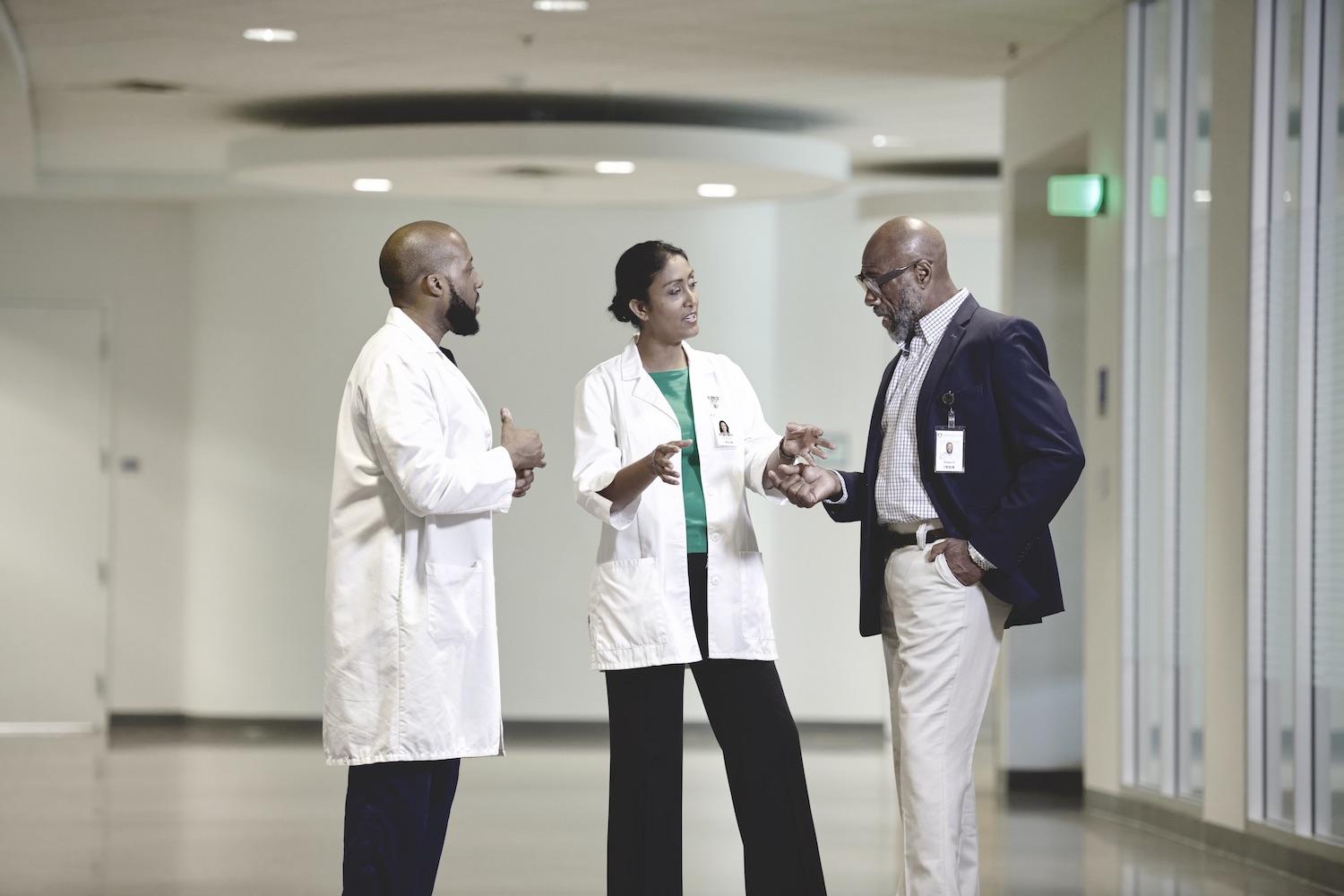 Doctors talking in a hospital - ensuring diversity in clinical trials