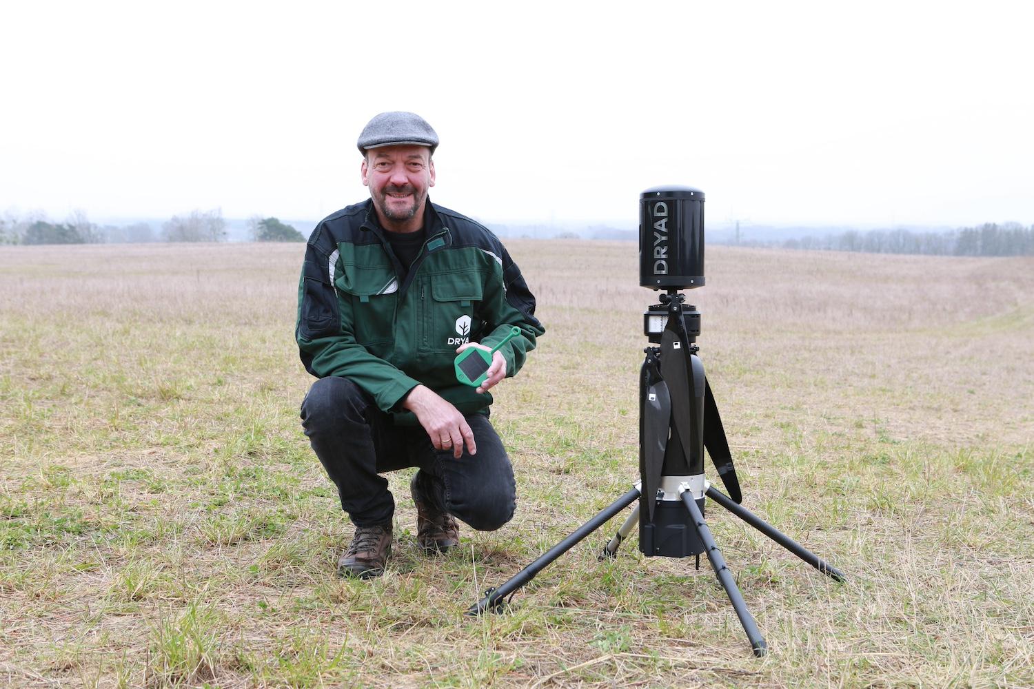 Dryad Networks CEO Carsten Brinkshulte holds a Silvanet wildfire sensor next to a Silvaguard drone that responds to wildfires.