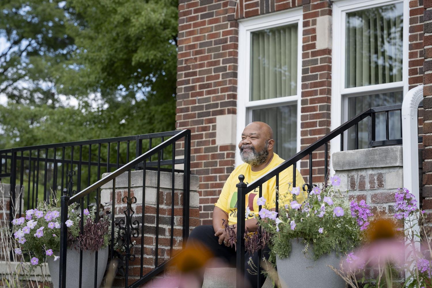 Jeffrey Jones, executive director of Hope Village Revitalization, sits on the front steps of the La Salle Eco-Demonstration Home.