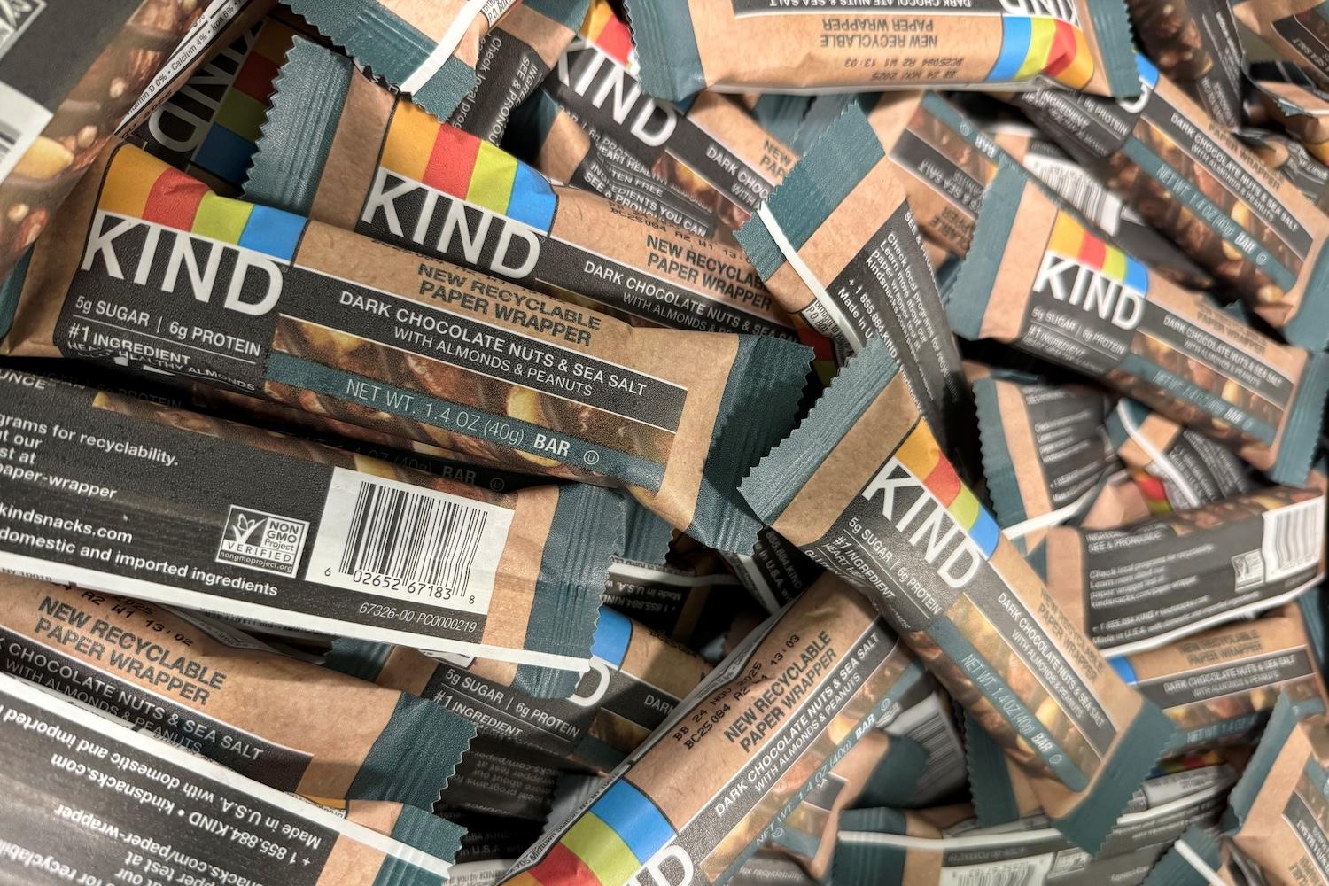 A pile of dark chocolate nuts and sea salt Kind bars in the new recyclable paper wrappers.