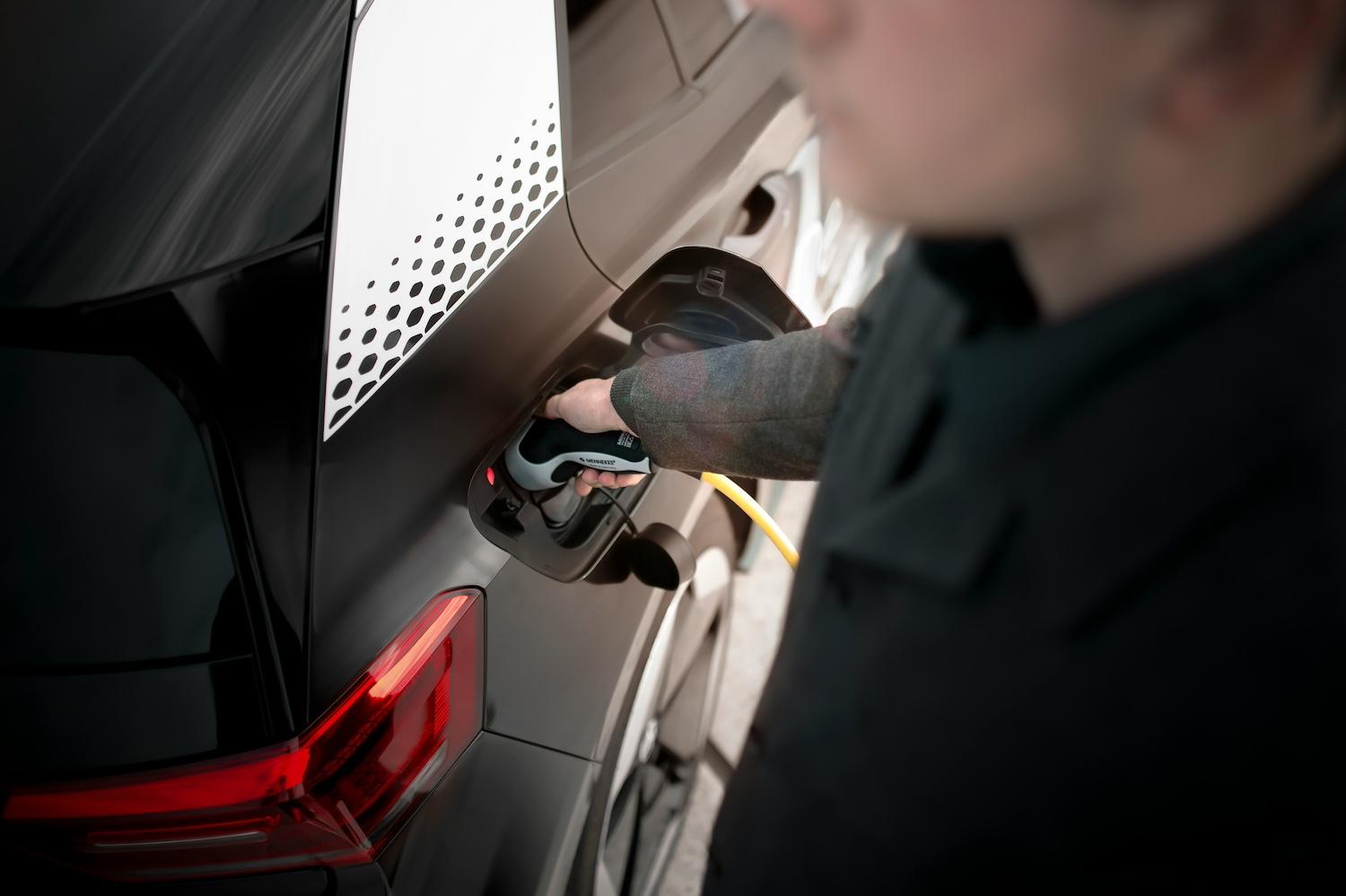 A person charging an EV  — Lithium-ion