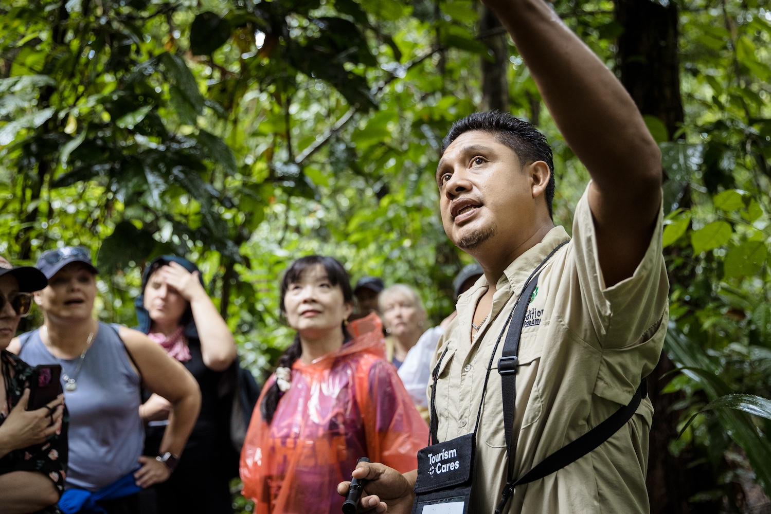 A local guide points out Panama’s biodiversity while walking through the rainforest with travelers — Meaningful Travel Map