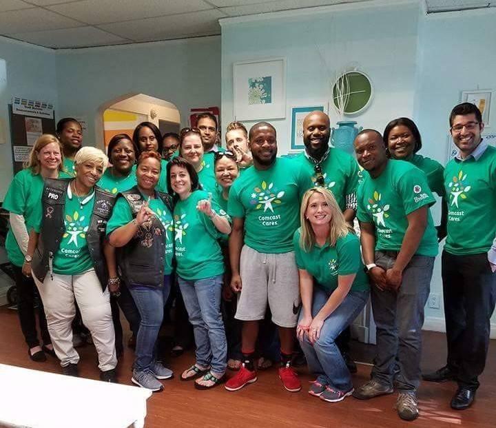 Monica-Lane-middle-row-second-from-the-left-and-her-crew-of-volunteers-at-Nicholas-House-during-the-2017-Comcast-Cares-Day.jpg