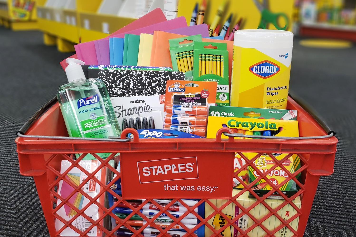 School supplies in a Staples shopping basket. 