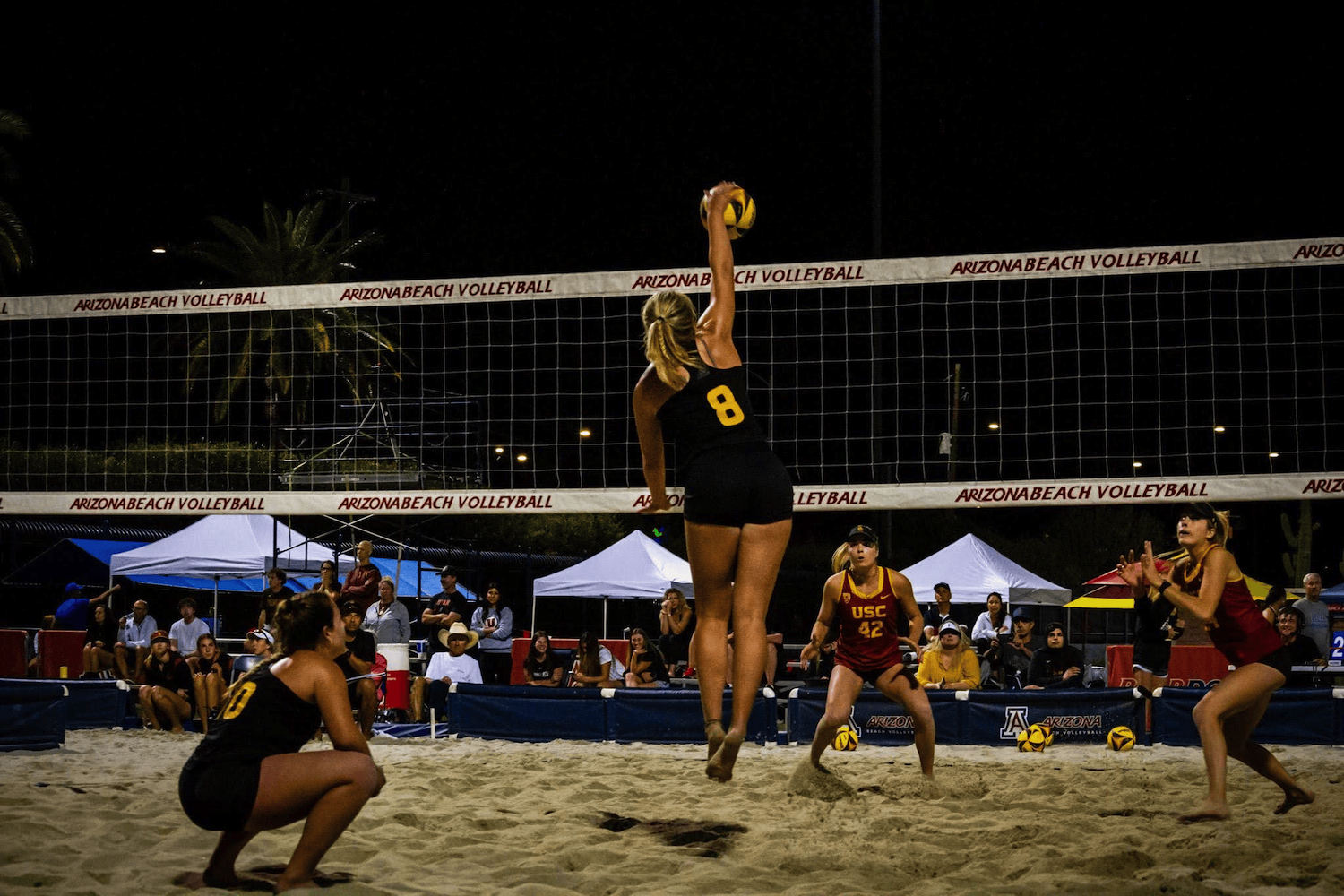 Kate Fitzgerald jumps up to spike a volleyball during an ASU game — student-athletes
