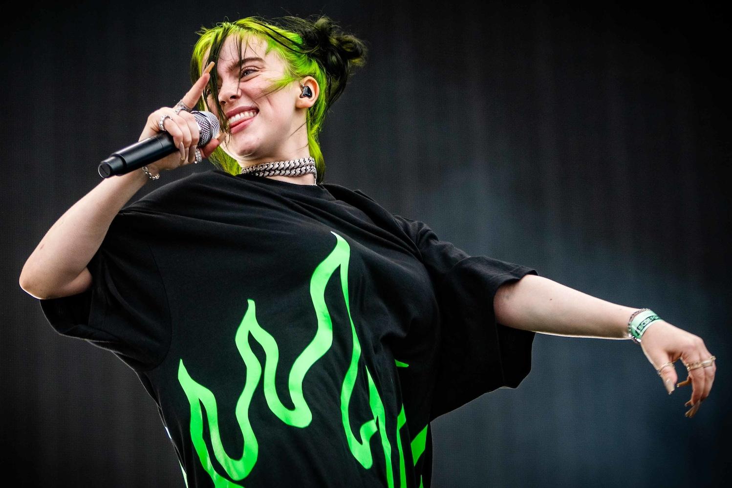 Billie Eilish singing into a mic. 