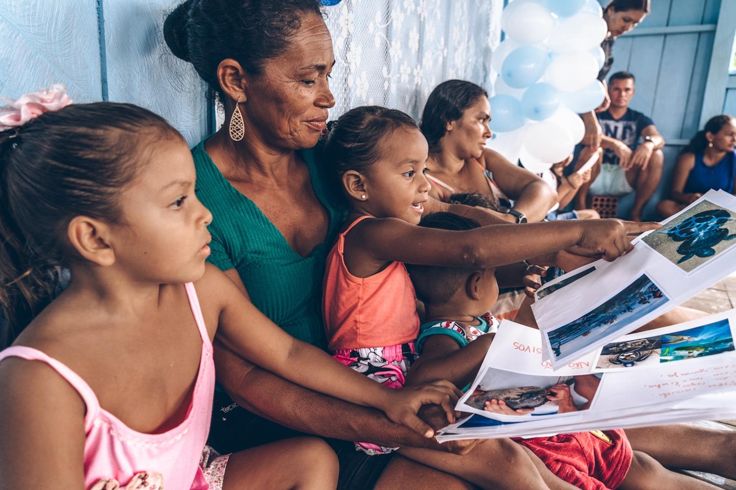 Children and adults sit together participating in The Waterschool curriculum in Brazil — Swarovski Foundation
