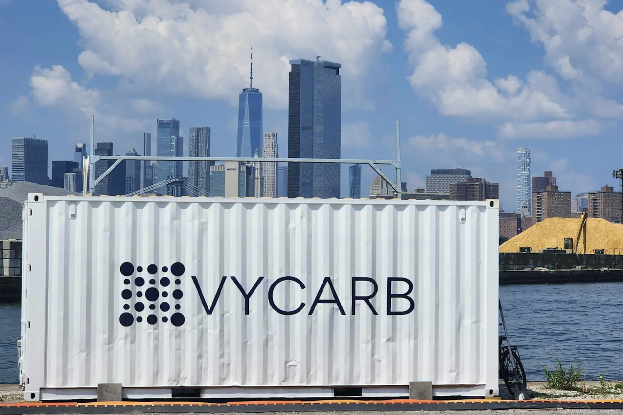 A Vycarb trailer in front of the New York City skyline along the East River — carbon dioxide removal