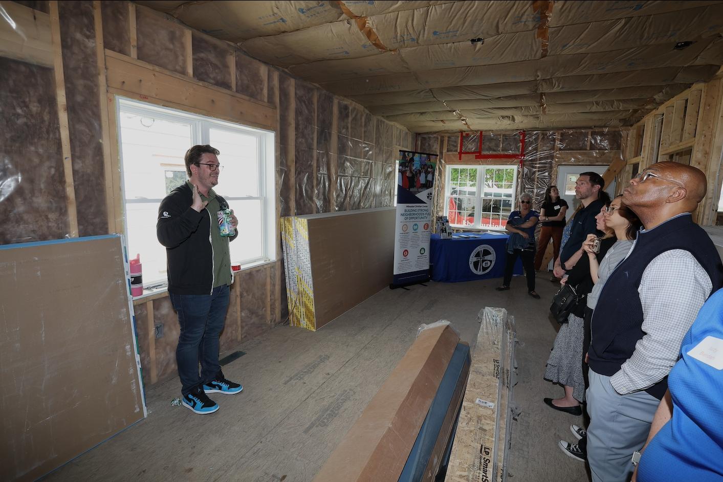 Grady Crosby the wooden foundation of an affordable home under construction with a group of others — affordable housing