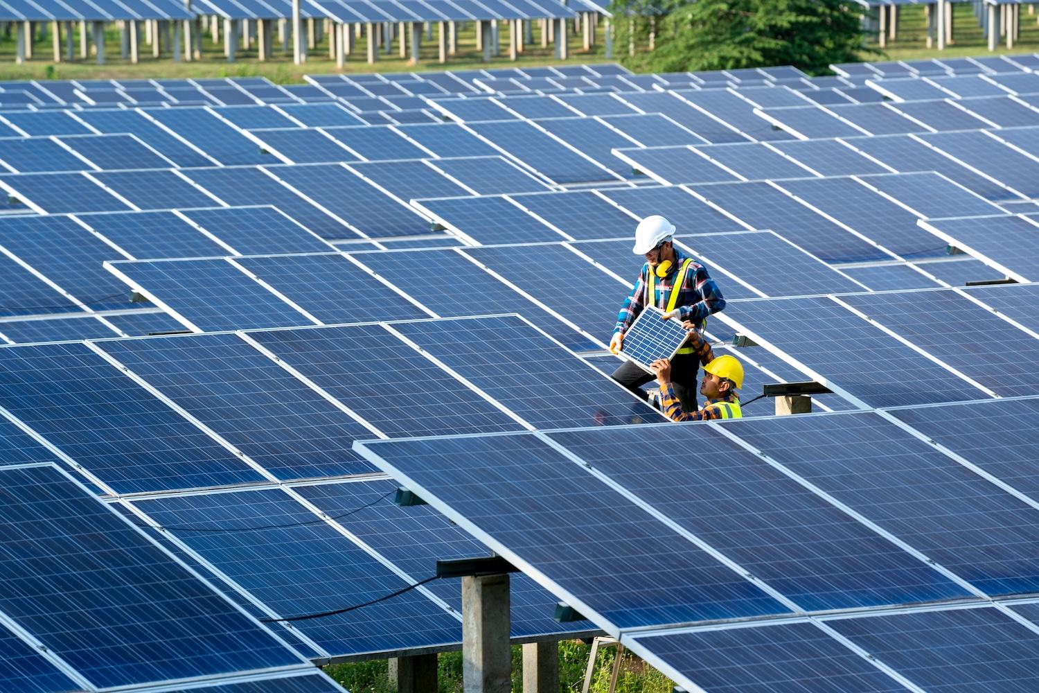 clean energy construction workers building solar farm