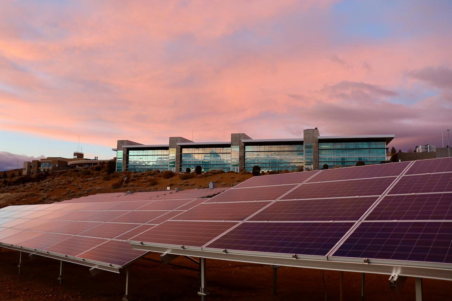 Solar panels in front of a building — climate reporting