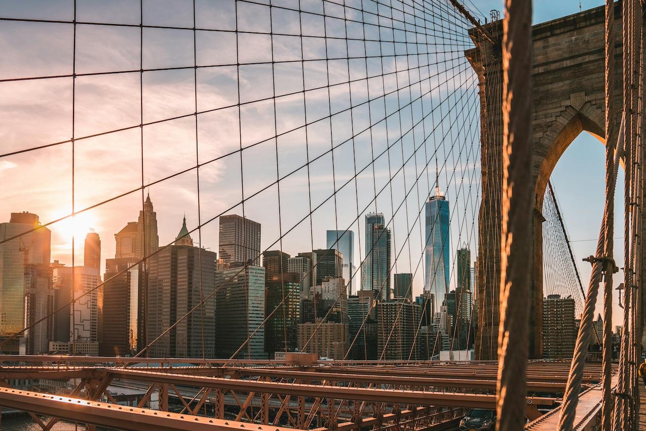 The Brooklyn Bridge during golden hour with the New York City skyline behind it — embodied carbon