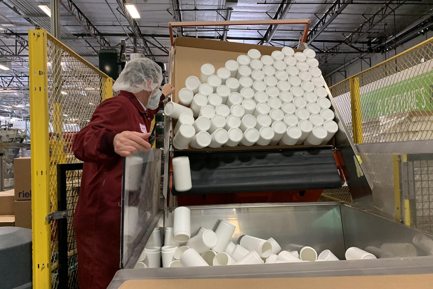 empty canisters being processed for recycling