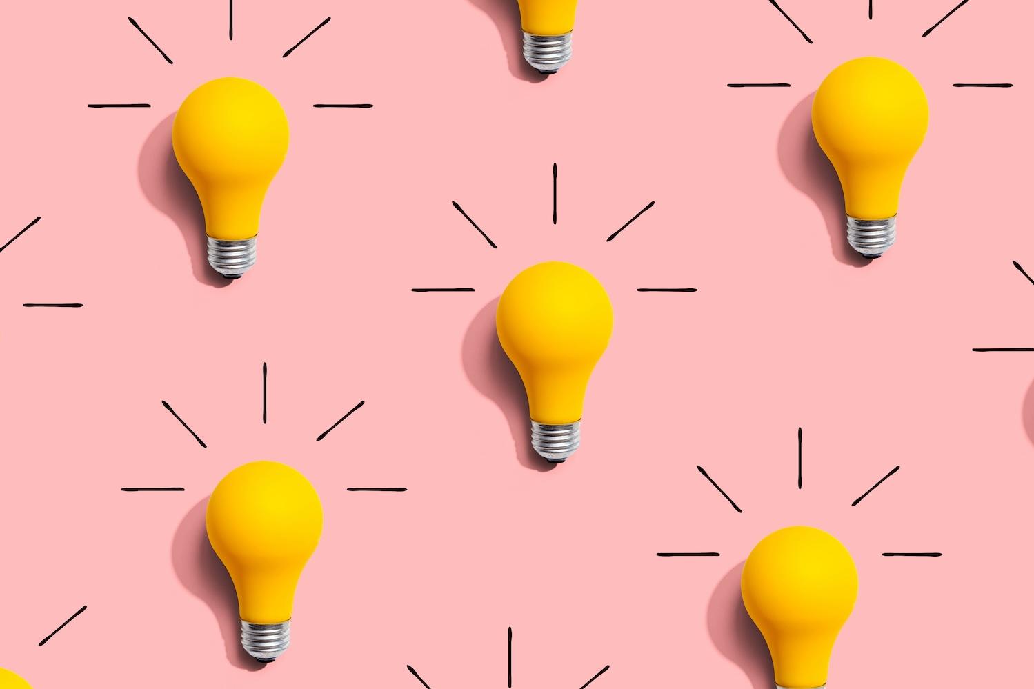 graphic of light bulbs on a pink background representing ideas and predictions for brand purpose in 2025