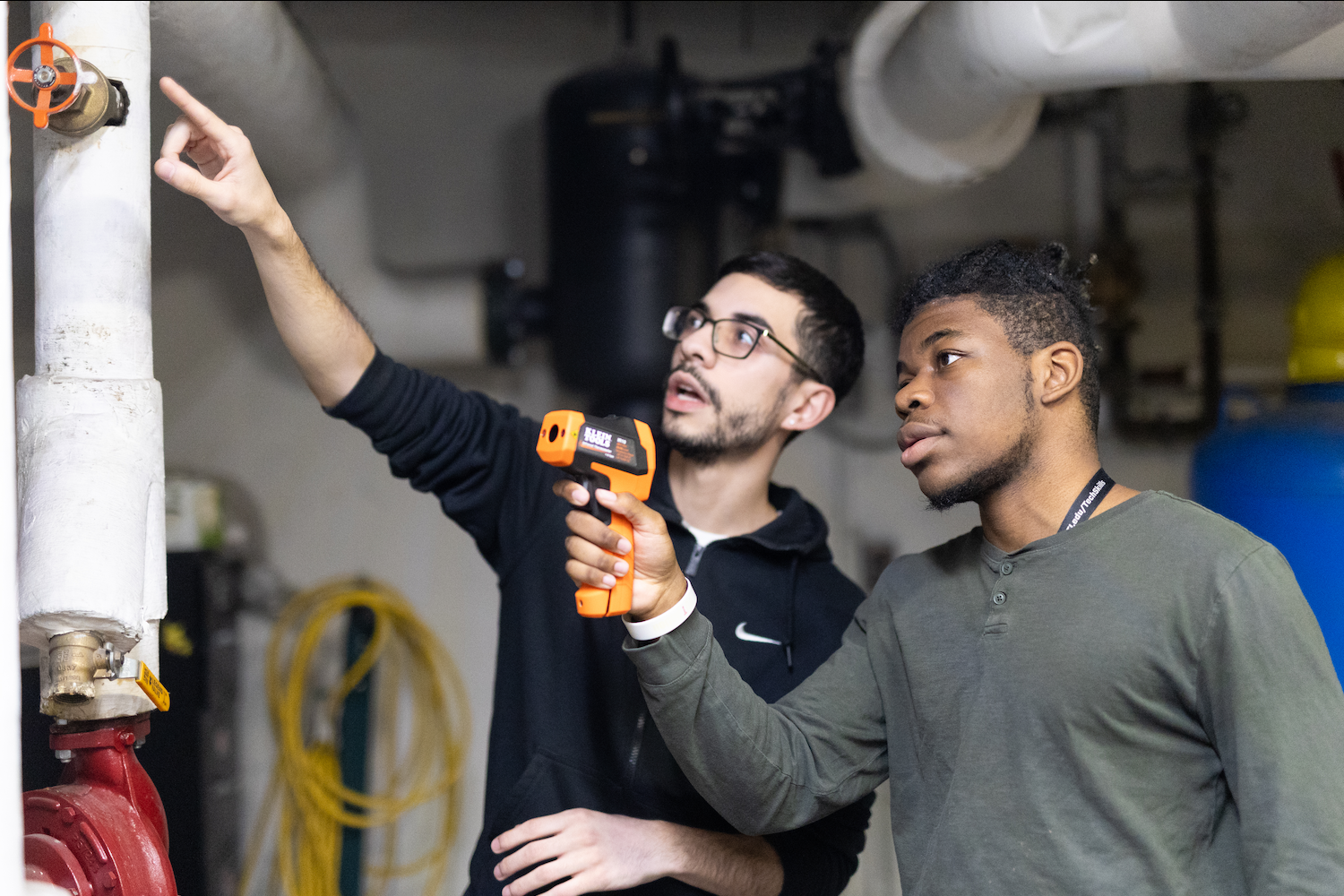 David Sepulveda advising a student during a hands-on green building lesson — green jobs