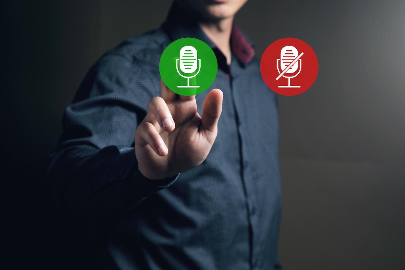 icons of enabled and disabled microphone. Man tapping on the screen — metaphor for whether companies should make their sustainability goals public or not