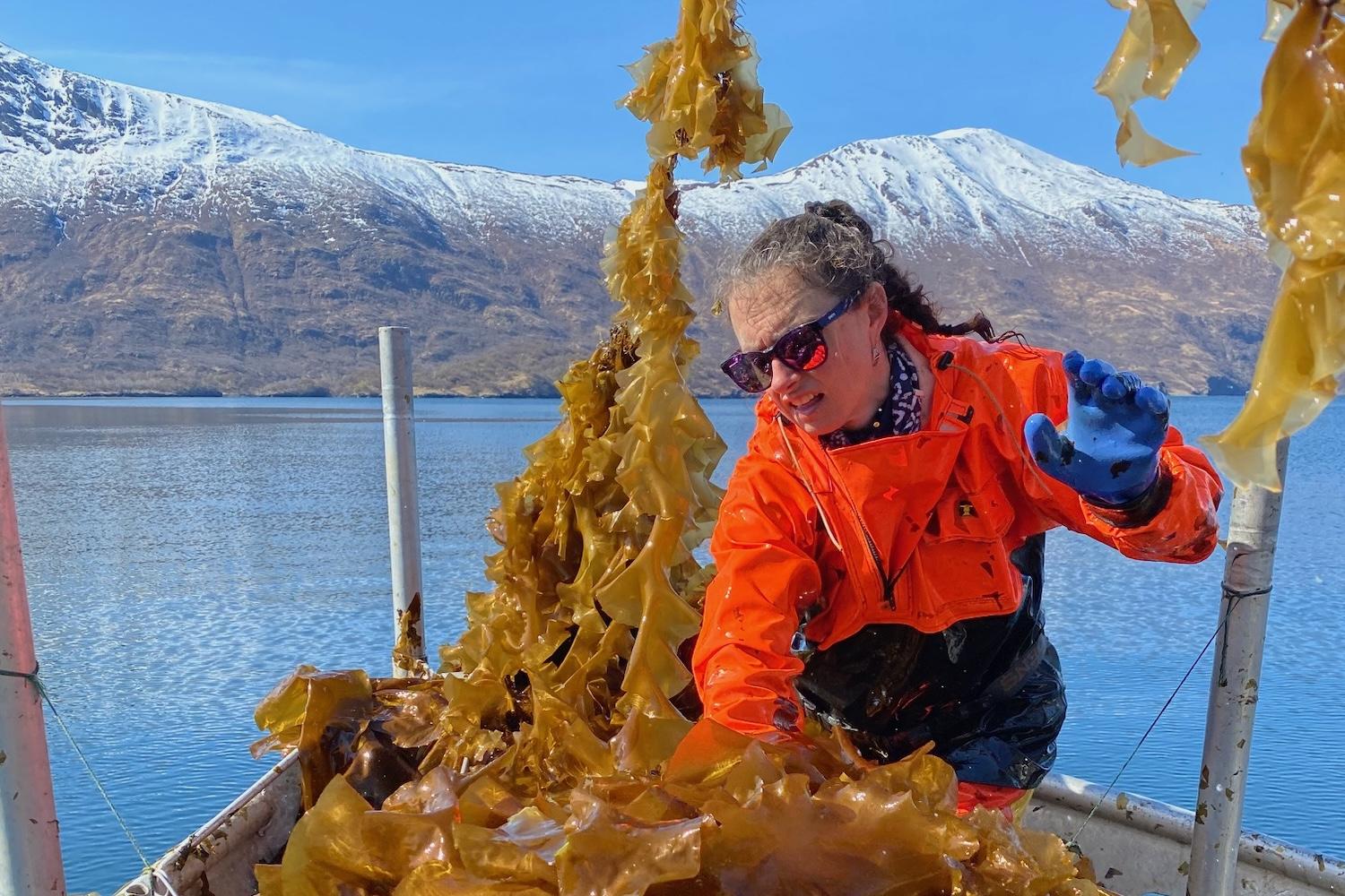 woman on a boat in Alaska processing seaweed for use in SuperCrude