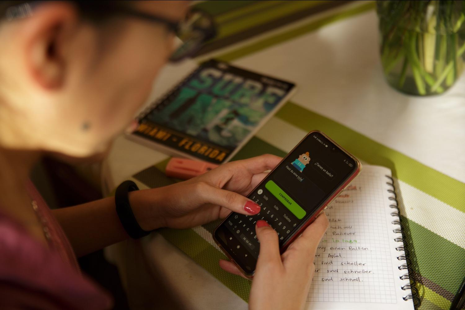 A person uses the Duolingo app on their cell phone — immigrant entrepreneurs