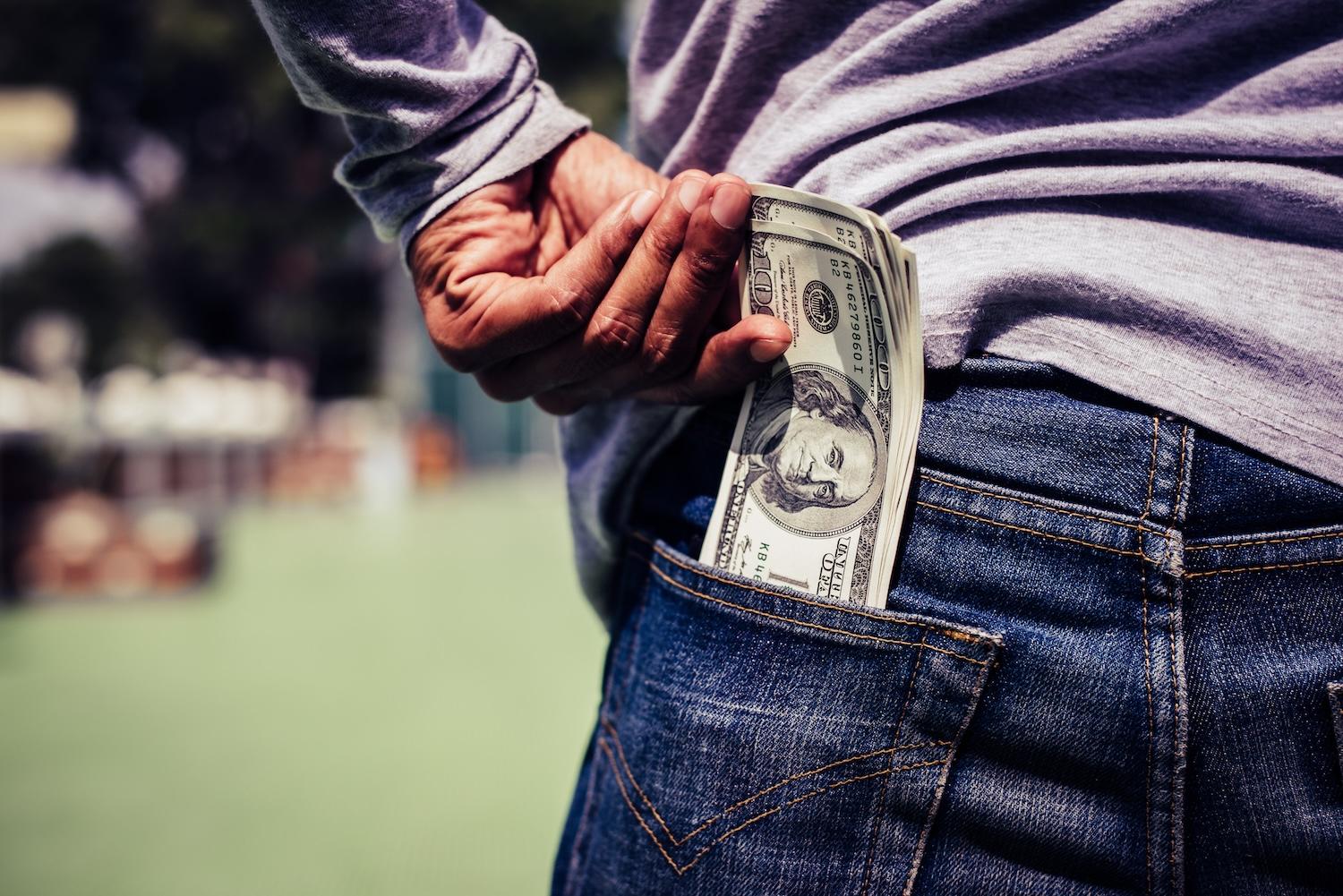 man puts money in his pocket — climate finance — we have change in our pockets — vote with your dollar