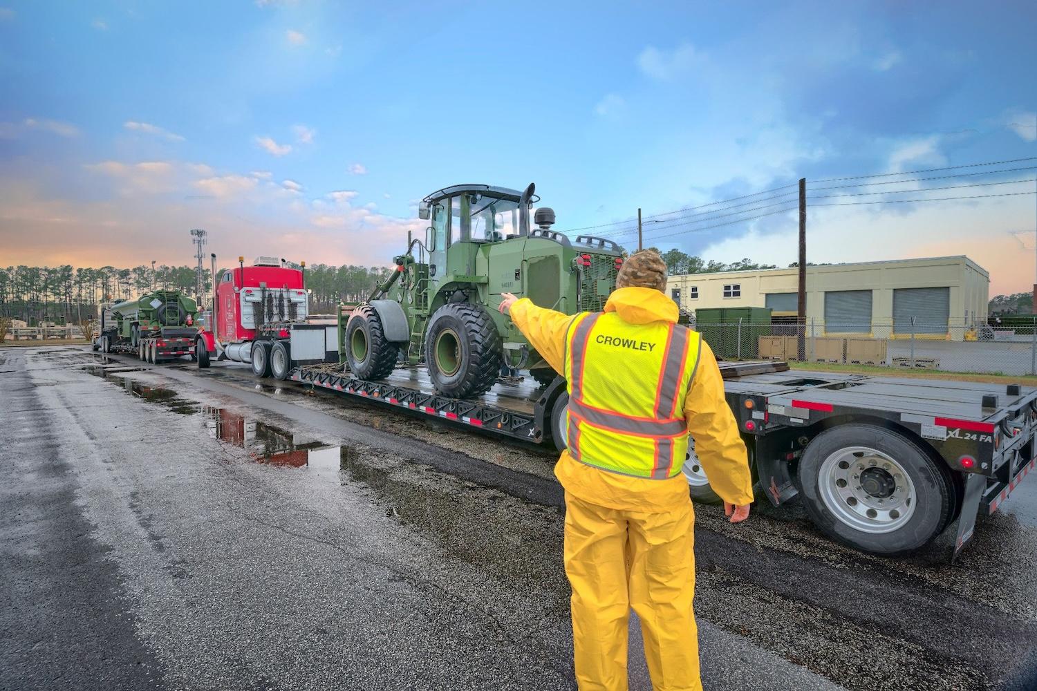 man with crowley vest on standing by line of trucks copy