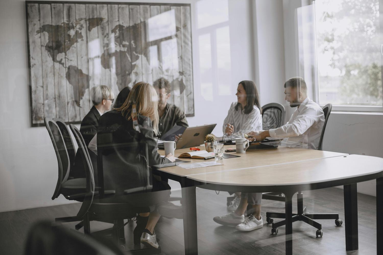 People sit in a conference room — menopause friendly workplace