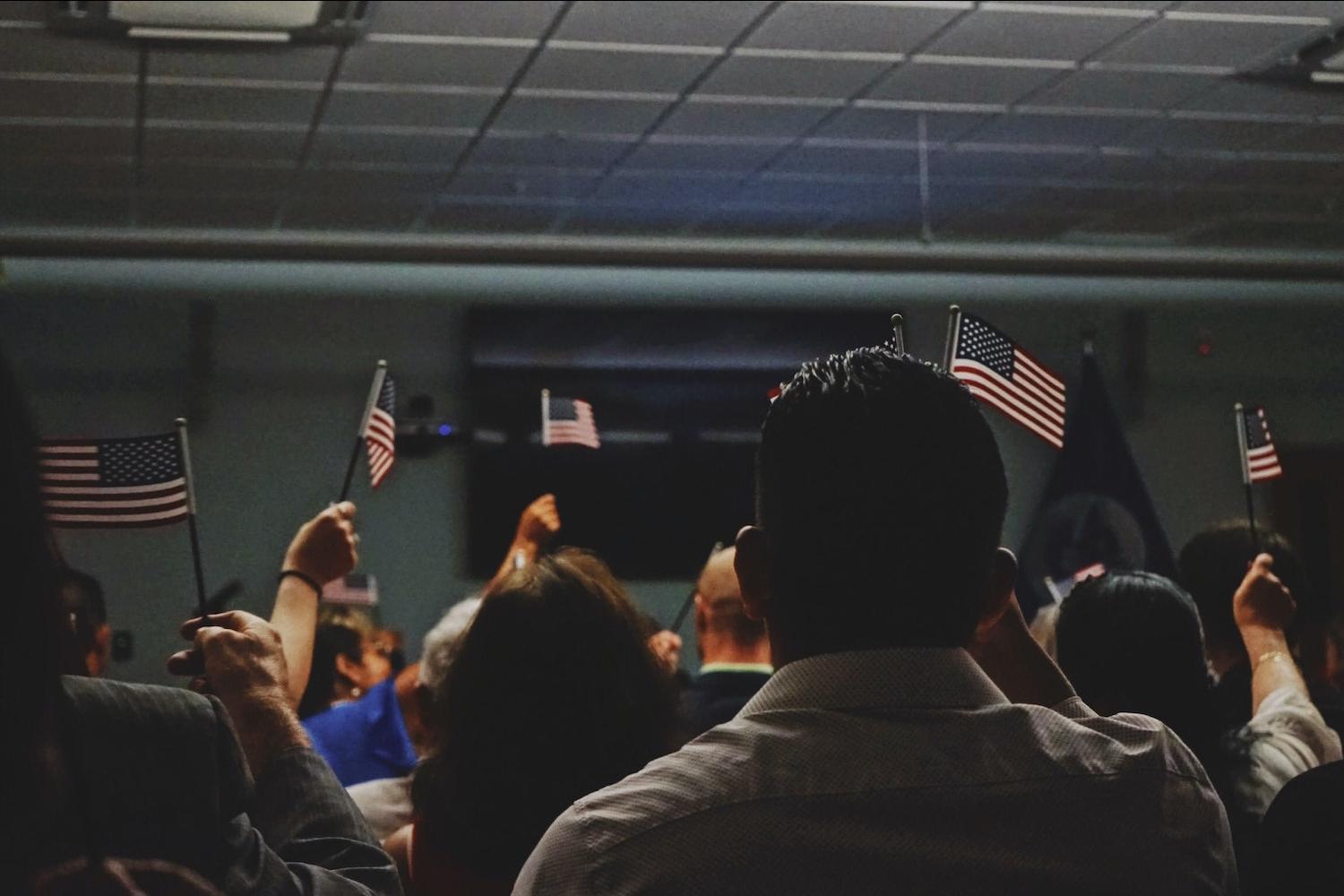 people holding american flags - immigration