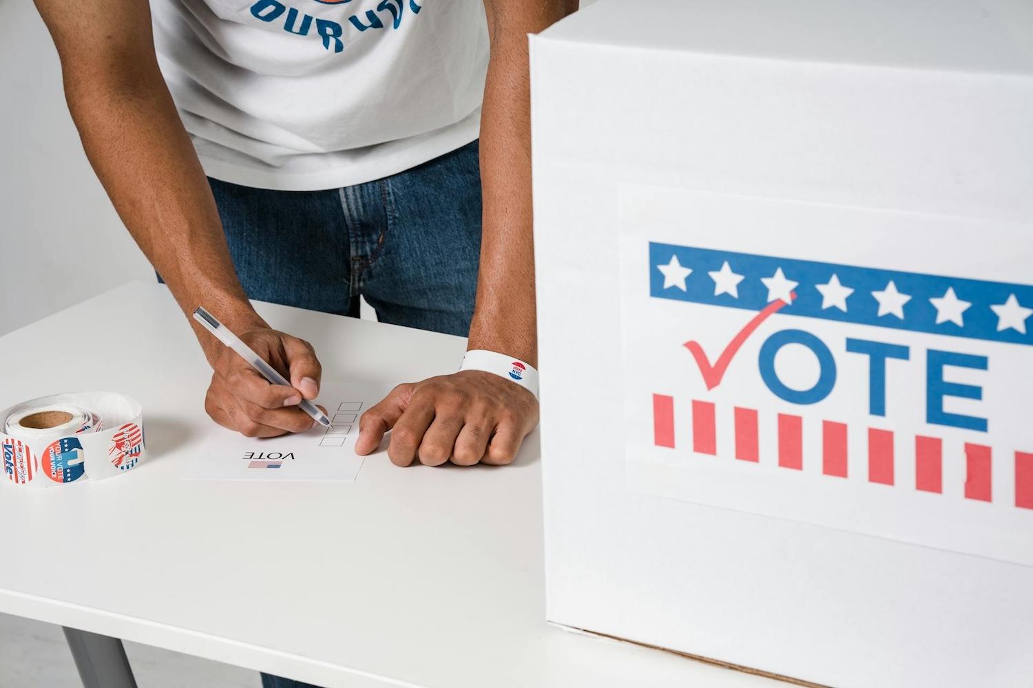 person registering to vote — new business pledge calls on US candidates to support free and fair elections