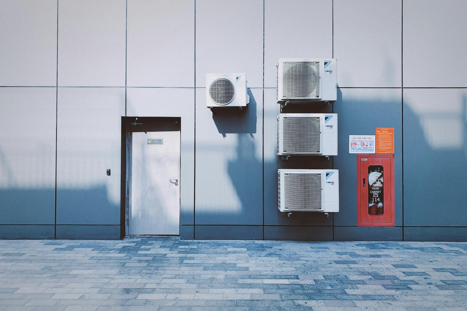 Air conditioning units on a wall — refrigerant emissions