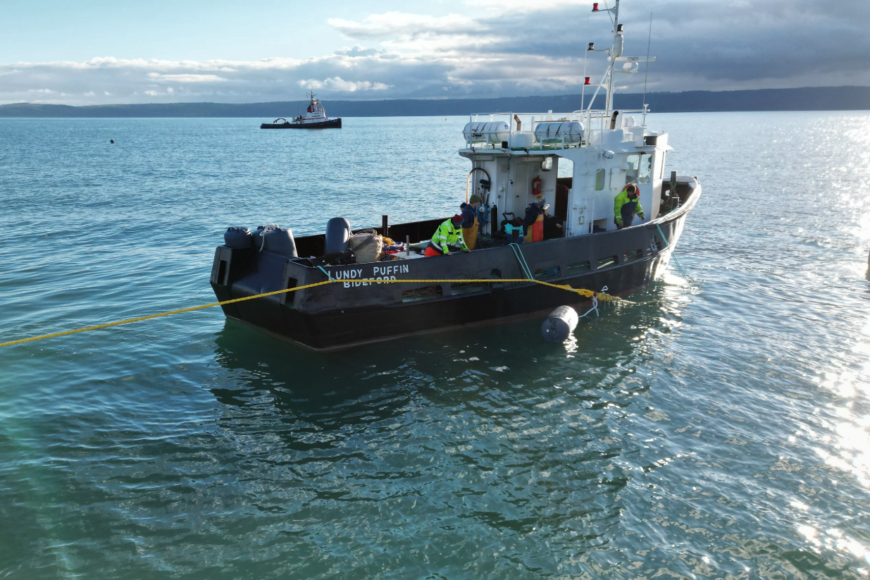 A ship named the Lundy Puffin placing ropes in the water to build the Blue Forest project farm — aquaculture