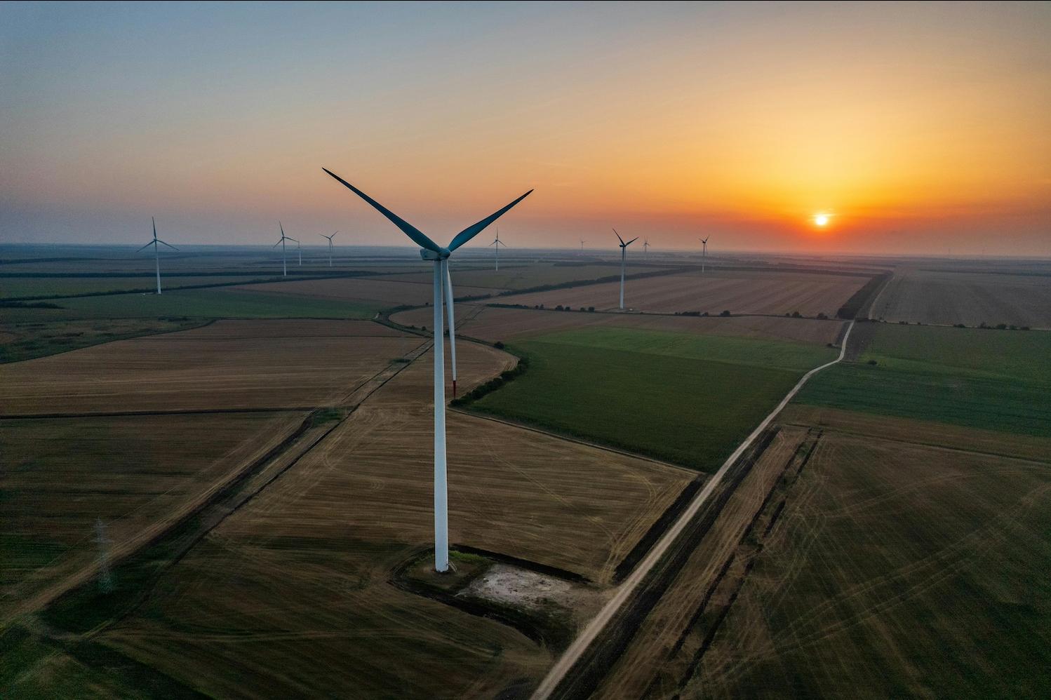 A wind farm at sunset — renewable energy 